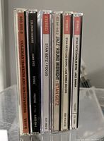 Photo of six CD jewel cases in a row showing the spines and titles. Includes jazz albums by Coleman Hawkins and Stan Getz.
