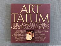 Box cover showing title 'Art Tatum The Complete Pablo Group Masterpieces' with list of featured artists in gold text on burgundy background.