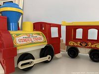 Close-up of the front and side of the Fisher Price Circus Train locomotive showing the colorful label and wheel details.