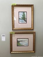 Two framed and signed Port Dover watercolours, one above the other on a beige wall showing size and detail.