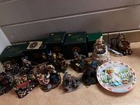 Overview of Boyds Bears Bearstone collection figurines including several bears in different poses and original green boxes, along with a bear-themed decorative plate titled Summer.