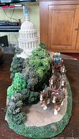 Front side of figurine showing four Clydesdale horses in harness and U.S. Capitol dome in the background.