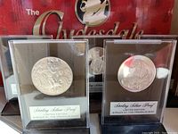 Two Sterling Silver Proof limited edition Franklin Mint medallions in clear plastic display holders