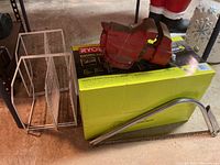 Ryobi pressure washer box, metal vise, wire shelving, and metal saw shown together to depict lot contents.