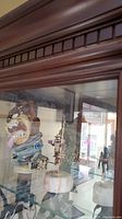 Photo showing Tasmanian Devil stein and carousel figurine inside display cabinet