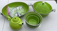 Full set view including large covered pot, teapot, nested bowls, and flatware bag