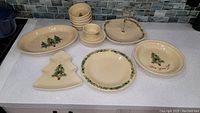 All items arranged on a countertop showing cream color with Christmas tree motifs and holiday decorations