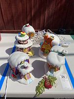 Overall view of five ceramic Whoville Village buildings arranged on table