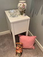 White side table with drawer and Portmeirion Botanic Garden vase, clear glass bowl, pink cushion and small floral arrangement in wooden holder