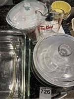 Overall set including glass baking pans, white casserole, measuring cup, and yellow ceramic dishes.