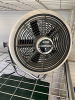 Front view of the Turbo-Aire 12-inch high velocity fan with protective grill and blades visible, showing Seabreeze Turbo-Aire logo.