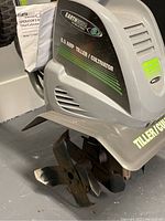 Close-up of tiller motor housing showing Earthwise brand and 8.5 AMP Tiller/Cultivator label