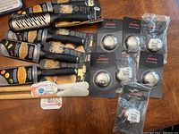 Overview of all kitchen items showing the wooden spatulas, metal graters, and packaged bottle openers on a wooden surface