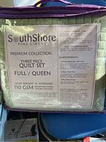 Packaged South Shore Fine Linens Premium Collection 3 piece full/queen quilt set with label showing details of fabric and measurements.