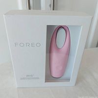 Front of the sealed Foreo IRIS eye massager box showing the petal pink device inside.