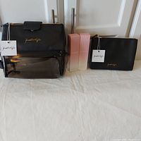 Full lot showing Kendall & Kylie travel case and makeup pouch with two KylieSkin moisturizers, all new with tags and boxes.