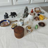 Wide view of entire lot showcasing all items including figurines, containers, a mirror, and small decorative pieces.