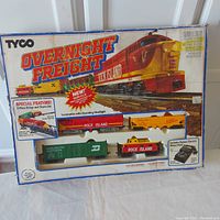 Full boxed Tyco Overnight Freight HO scale train set showing locomotive, cars, bridge, and power pack in original packaging.