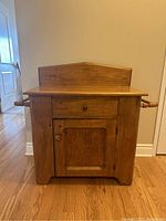 Front view of washstand showing drawer, door and backsplash