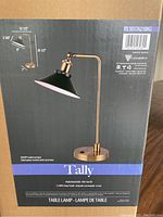 Box showing image and dimensions of Tally brand matte black and gold desk lamp, 20.5 inches high and 12.5 inches wide.