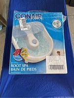 Conair Bubbling Foot Spa in original packaging showing front view with water bubbling illustration.