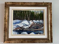 Front view of framed acrylic painting featuring a snowy forest and stream landscape