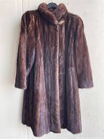 Front view of the brown medium-sized women's fur coat showing collar and vertical fur pattern