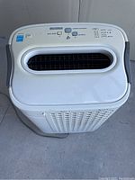 Front view of the white HEPA air purifier and humidifier unit showing air outlet grille and control panel with buttons.