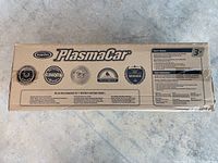Top of box showing PlaSmart PlasmaCar branding, awards, recognitions, and age recommendation 3+. The box is sealed and appears unused.