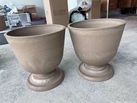 Two beige plastic planters side by side, showing the overall shape and color.