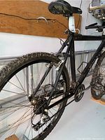 Rear three-quarter view showing cassette, derailleur, saddle, rear wheel