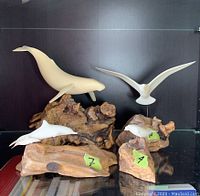 Four animal figures on natural wood bases displayed together, showing the full set.