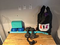 Full overview showing yoga block, resistance bar, dumbbells, half balls, skipping rope in tote bag.