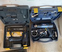 Open view of two Mastercraft brand tool cases showing heat blower kit on right and pneumatic nail shooter on left.