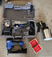 Full lot showing Dremel Saw-Max in case, Campbell Hausfeld nailer/stapler, spray painting apparatus, and boxes of nails