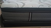Side view of mattress seated on box spring
