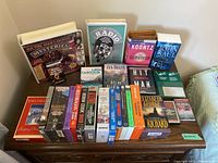 Wide view of all cassette audiobook tapes arranged on a table showing titles and authors.