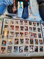 Photo showing 33 hockey cards laid out on a surface with other items around