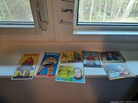 Overview of six hockey cards laid out on windowsill