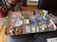 Photo of all items on large silver-tone metal tray including miniature figurines, Delft blue plates, and small decorative plates.