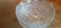 Top-down view of the crystal bowl showing the deep cut geometric pattern and scalloped rim.