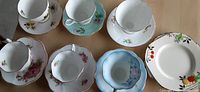Photo of six fine bone china cups and saucers with various floral patterns arrangement.
