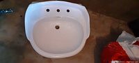 Top-down view of white porcelain basin showing overall shape and drain hole