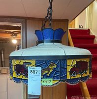 Front and side view of circular stained glass swag light with Mack truck images and dog motif, hanging chain visible.