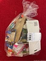 Photo of sealed clear bag containing multiple pencil sharpeners, some still in original packaging with cartoon graphics visible