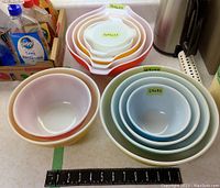 Top view of stacked Pyrex bowls with measurement ruler showing size range.
