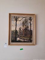 Full view of the framed landscape painting showing the entire artwork and frame hung on a wall.