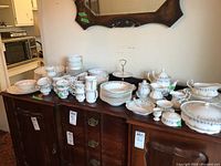 Overall view of the full china service and various serving pieces displayed on a table