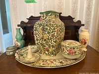 Shows entire 8 piece lot on oval porcelain tray with detailed floral designs, highlighting the Royal Doulton Persian vase, small vases, trinket box, and other china pieces.