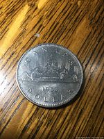 Reverse showing voyageur canoe design with CANADA 1983 DOLLAR inscription
